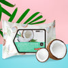 Image of a single pack of Coconut Water Makeup Remover Cleansing Tissues by Beauty Treats on a tropical pink, blue and green background.