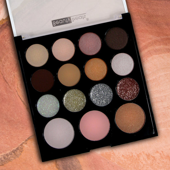 Image of a single palette of Beauty Treats' Modern Glitz Day to Night Palette on a champagne background.